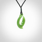 Hand made New Zealand Kahurangi Jade, hook, hei-matau pendant. Hand carved fish hook made from New Zealand jade. Carved by Ross Crump. Provided with adjustable black cord.